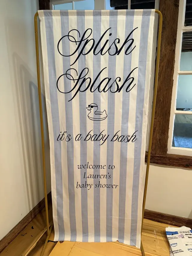 Blue and white striped fabric banner reading Splish Splash, it's a baby bash, for a baby shower